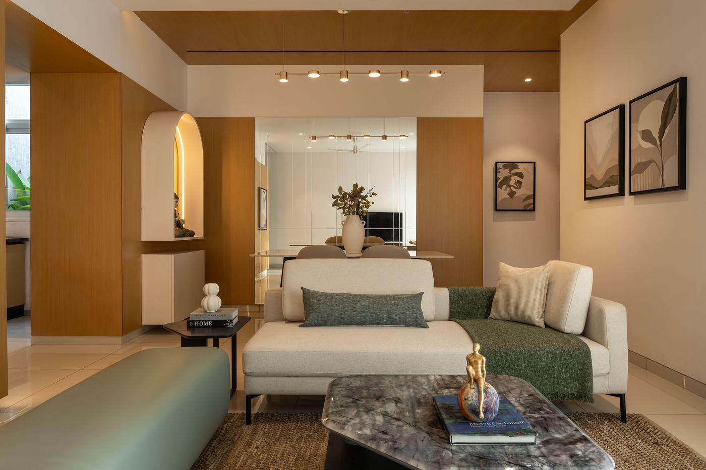 Living room with custom TV unit and arched mirror, a UDAIN'S Interiors residential project