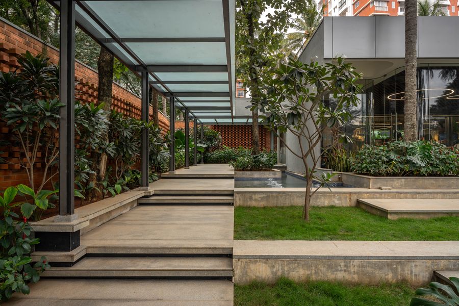 Glass pavilion structure among palms