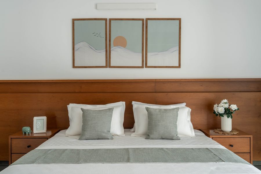 Bedroom in warm timber tones with pendant lighting